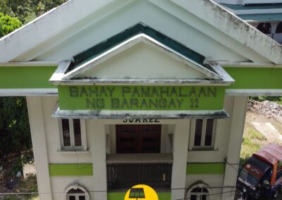 Front view of Bahay Pamahalaan ng Barangay 11 in Suarez, Quezon. Mount Solar Power Lucena partners with local barangays like this to bring solar energy solutions, supporting community development and clean power access in Quezon and Lucena.